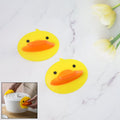 Duck silicone hot pot holder lifting a hot pot lid with secure grip