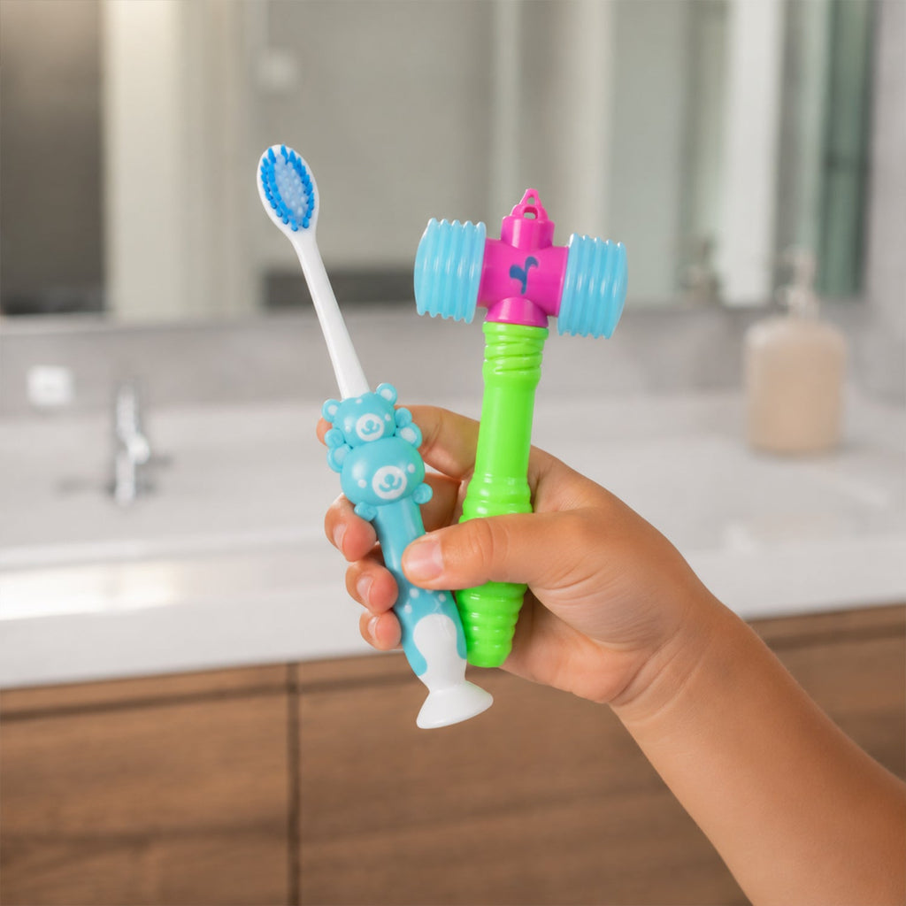 Child holding a blue toothbrush and yellow hammer toy