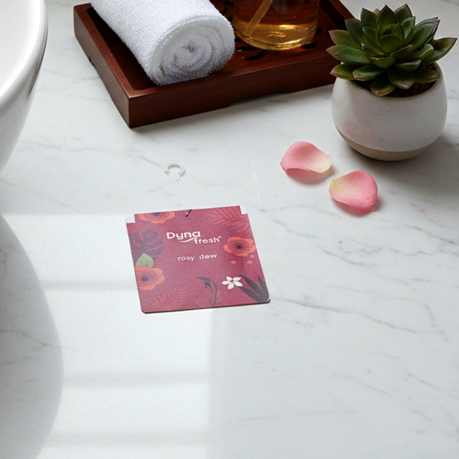 View of the compact Rosy Dew hanging gel air freshener, ready for use.