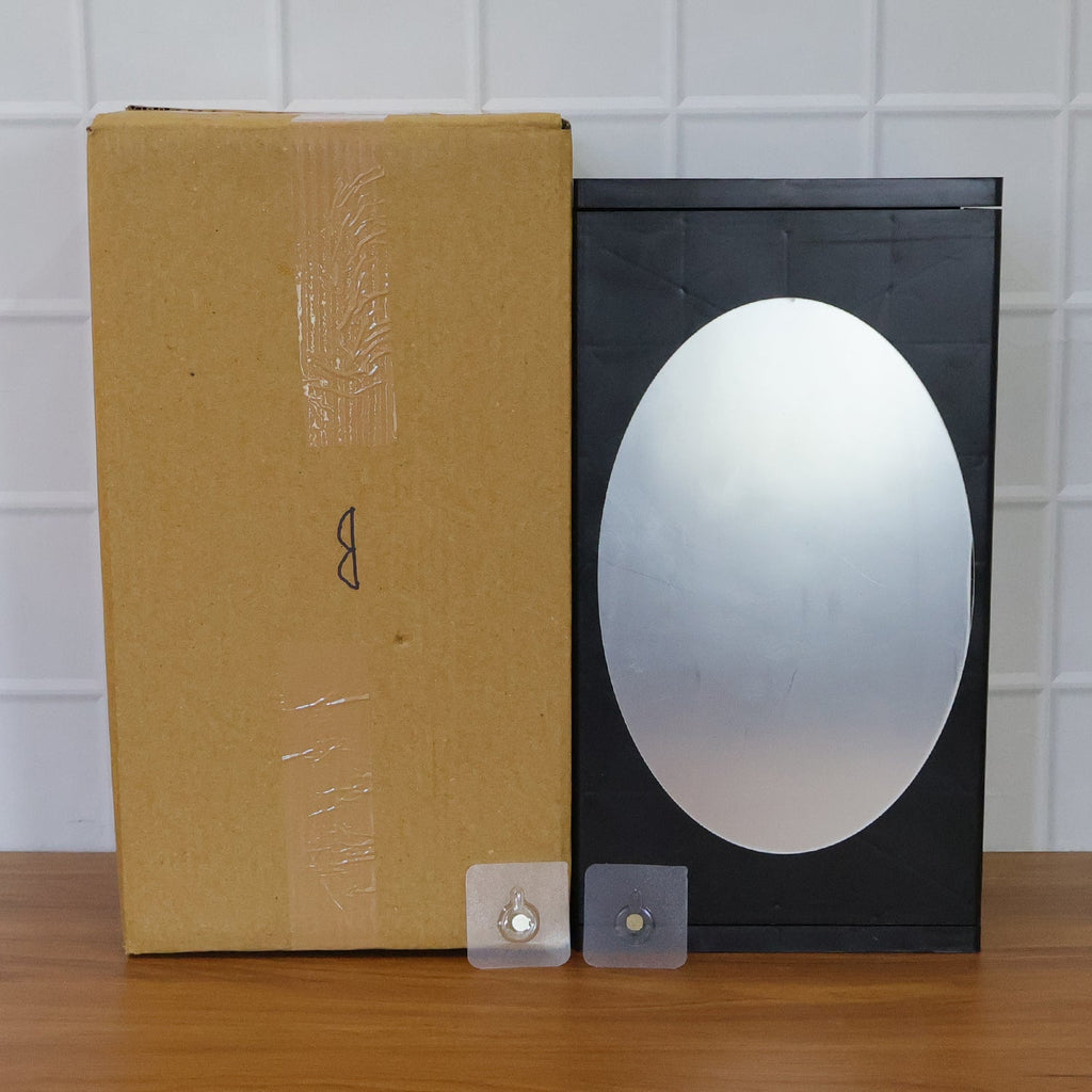 Stylish black wall-mounted storage box with front oval mirror for grooming essentials storage cabinet