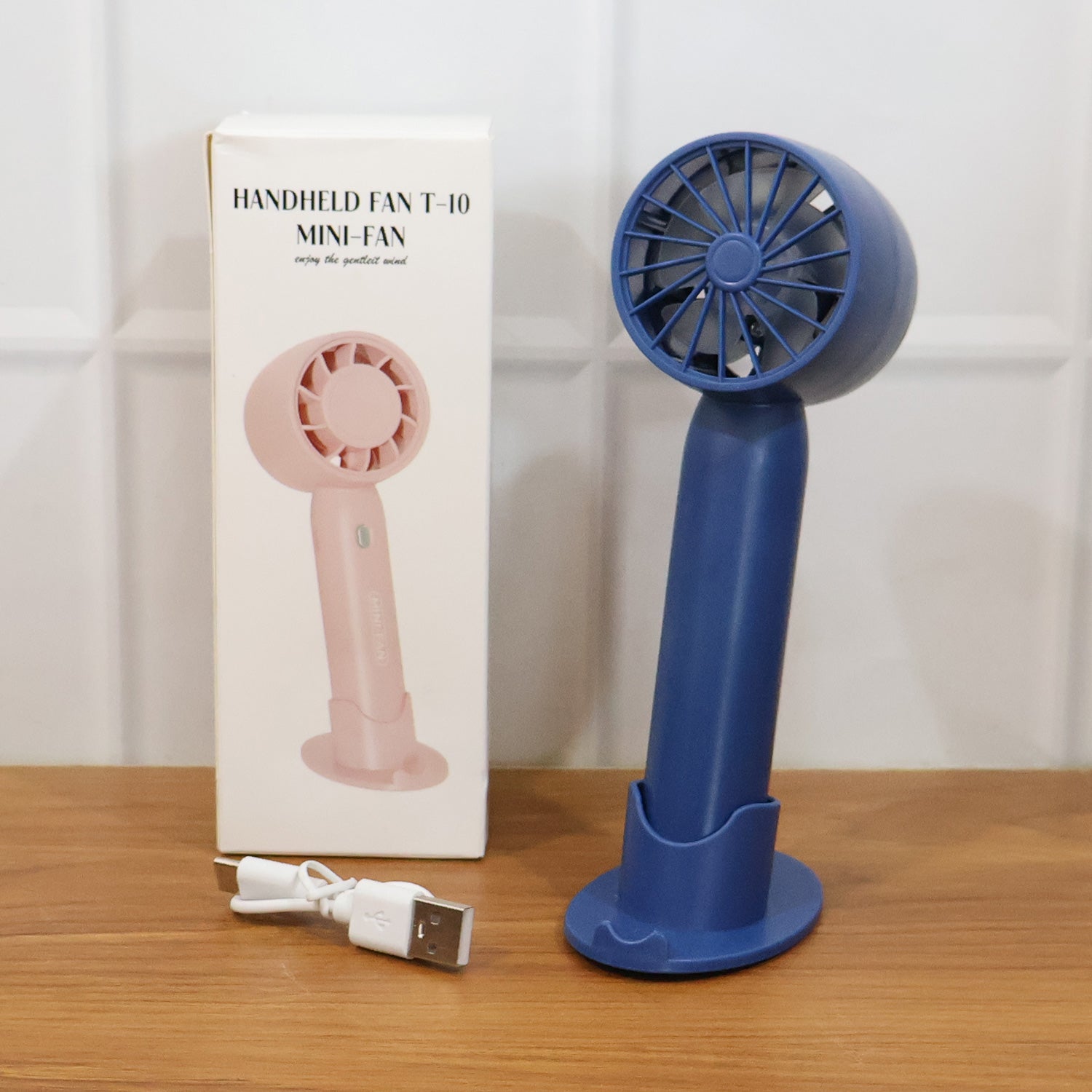 Comparison shot of rechargeable mini handheld fan size and design