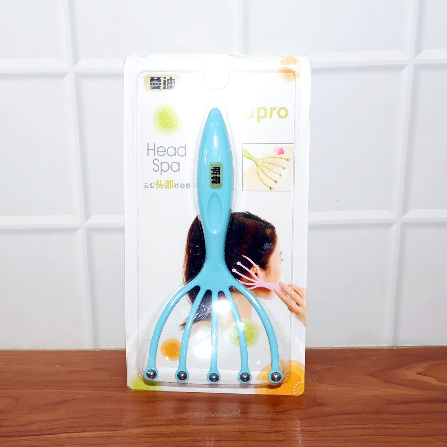 Five-finger head massager with rolling balls displayed on white background