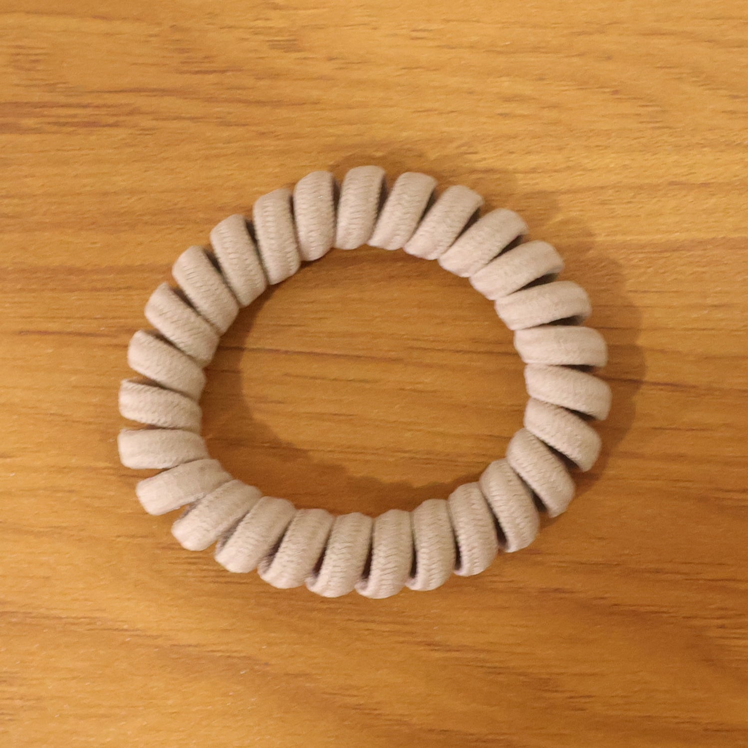 Multiple spiral coil hair bands in assorted shades, offering versatile styling.