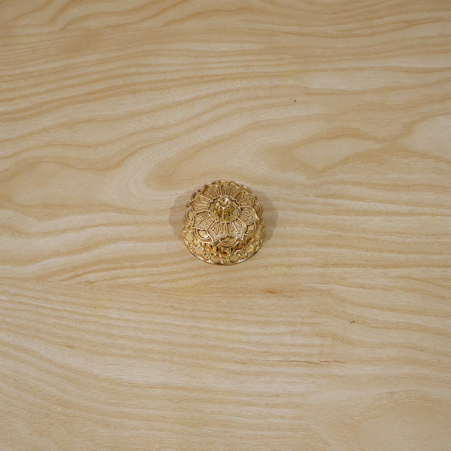Golden kankavati with lid in traditional pooja setting