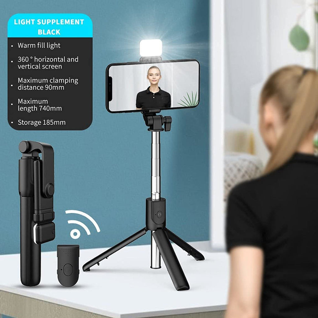 Extended wired selfie stick holding smartphone securely for wide angle selfies.