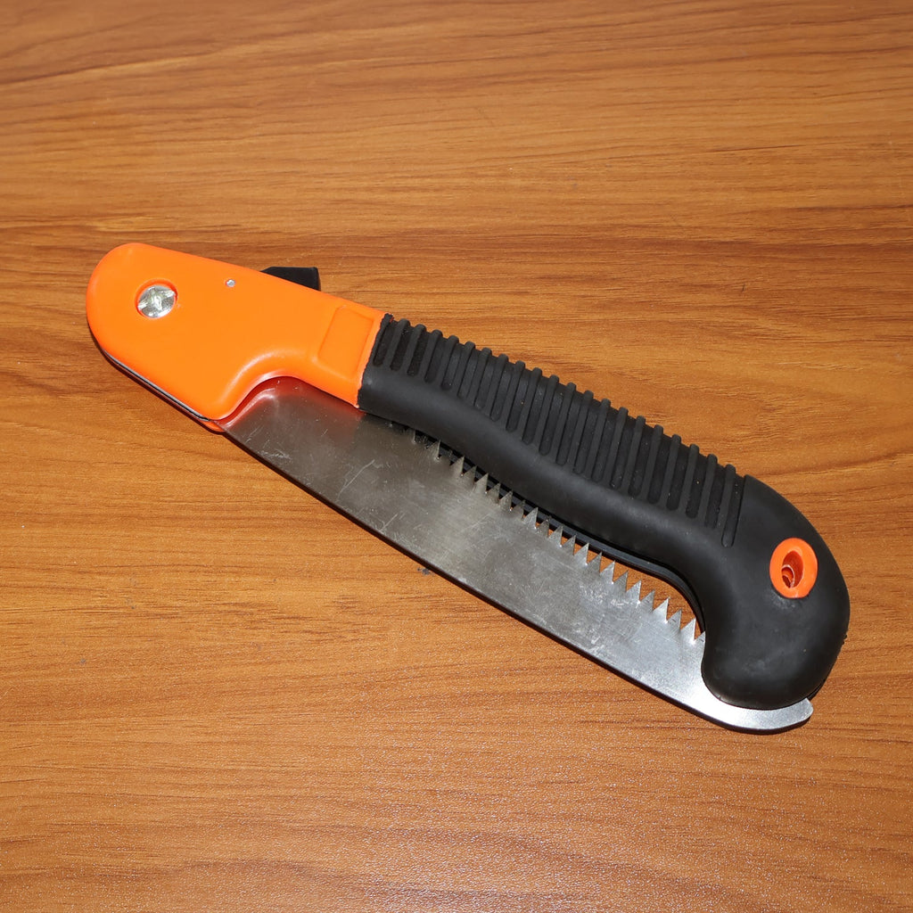 Folded garden hand saw tool safely stored