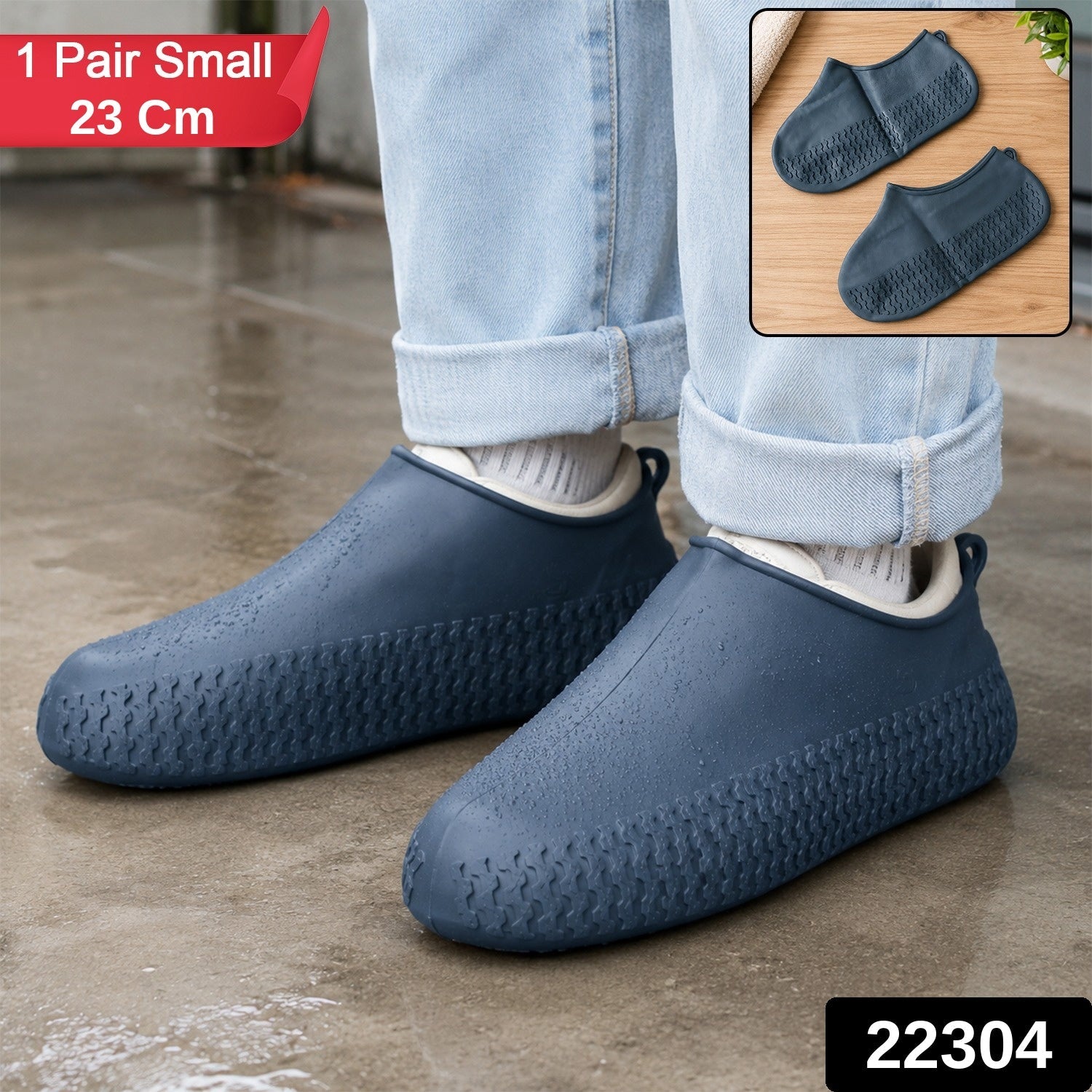A person wears navy blue silicone shoe covers over their shoes, standing on a wet surface, with product details in the