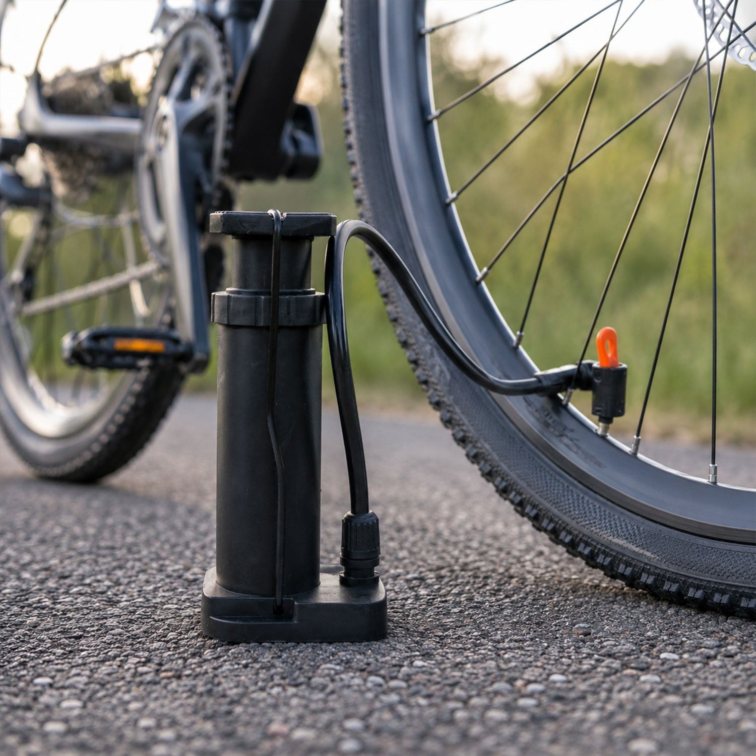 Mini pump inflating football and bicycle tire, versatile nozzles included
