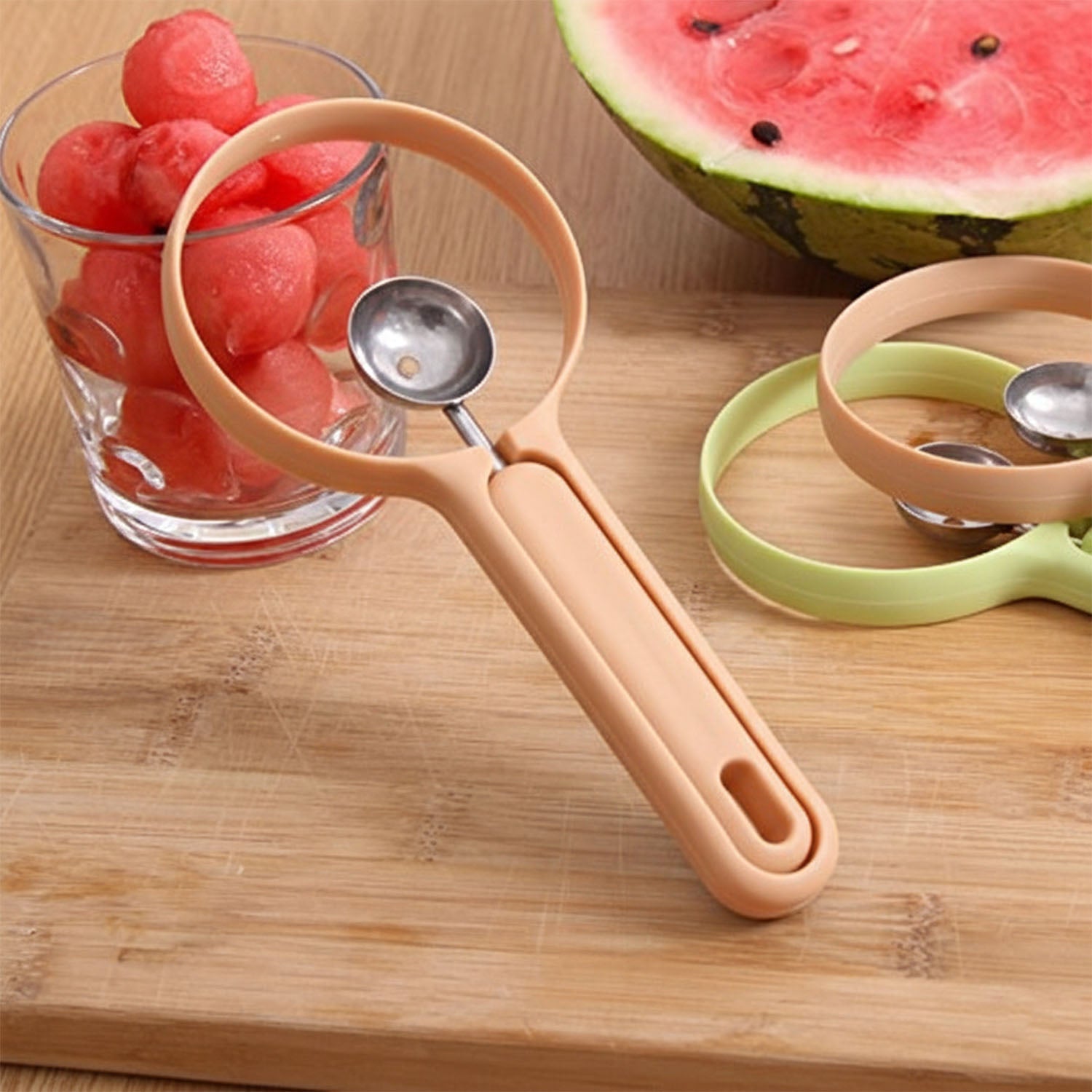 Fruit scooper and cutter tool displayed in kitchen setting