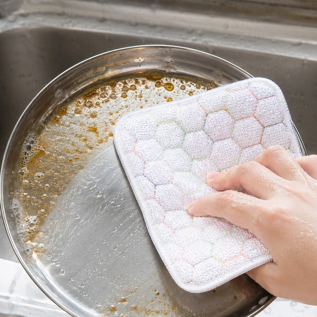 Kitchen utensils cleaning scrub pad in use