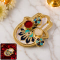 Decorative hand-shaped kumkum holder with enamel detailing for puja