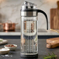 Glass oil dispenser bottle with handle and flip lid for kitchen
