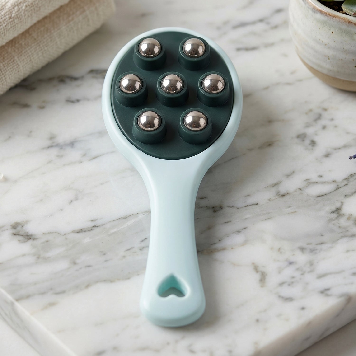 Ergonomic handheld body massager with 7 stainless steel balls.