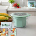 Manual vegetable grater with integrated storage bowl filled with shredded vegetables