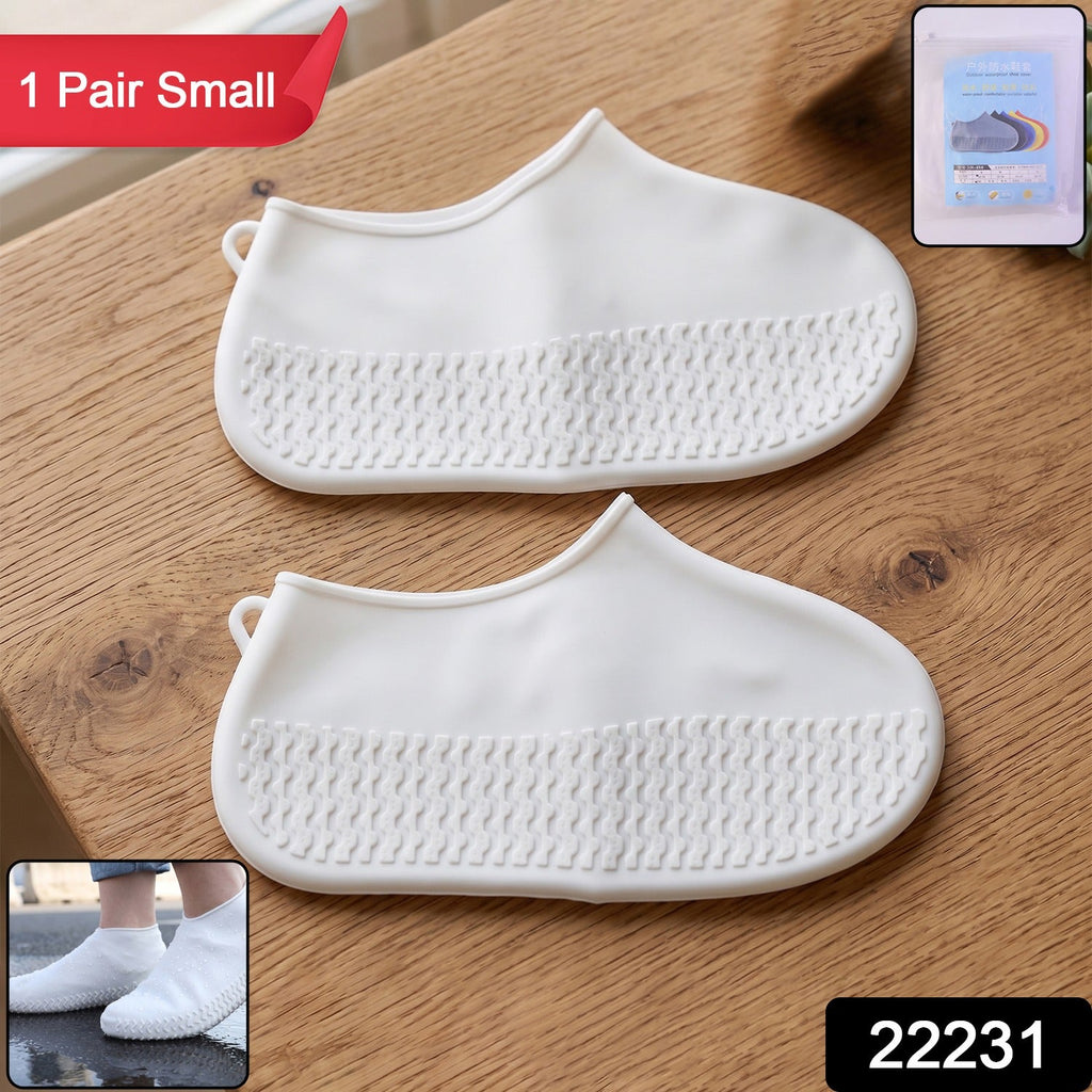 Pair of small white waterproof silicone rain shoe covers for outdoor use.