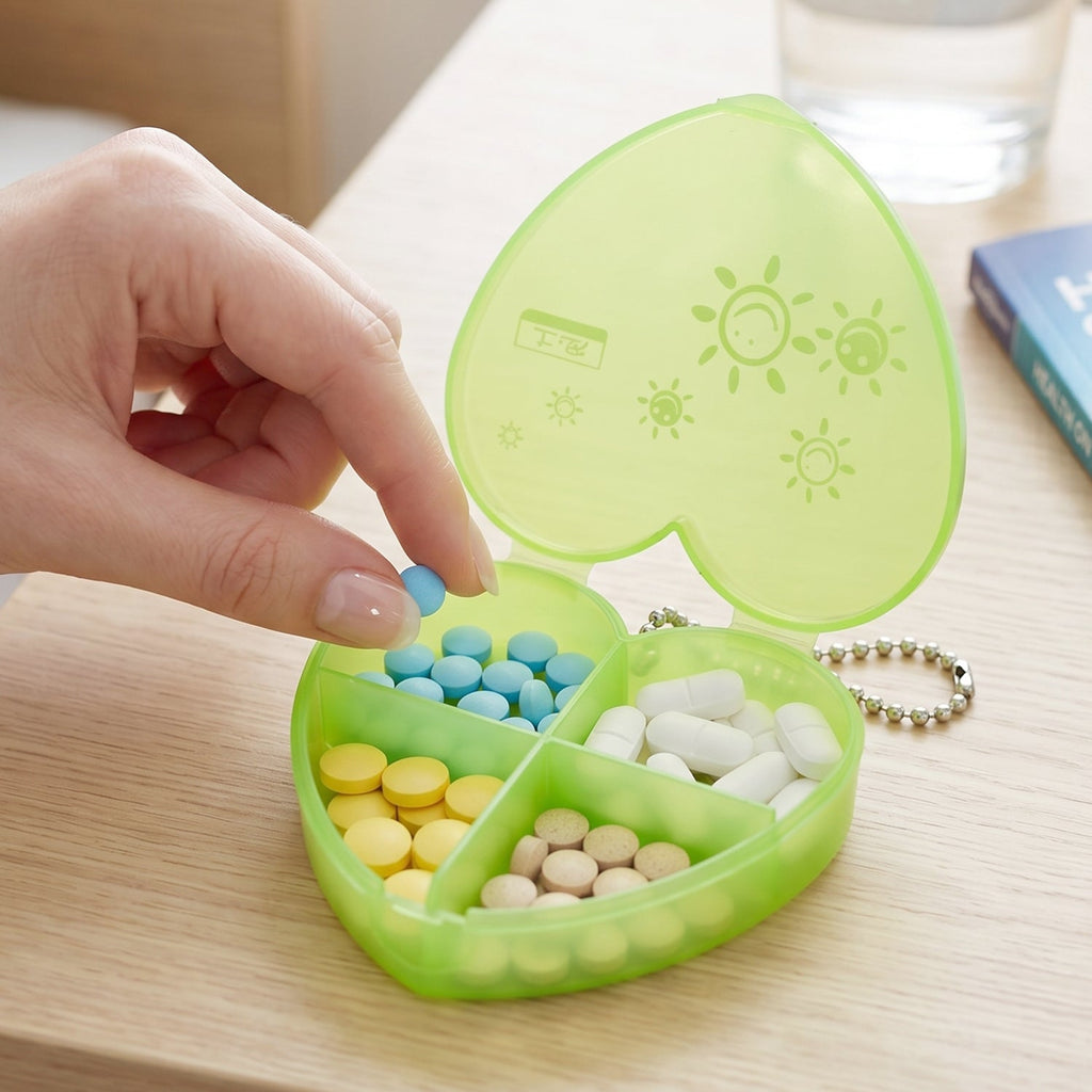Compact pill organizer held in hand showing four compartments
