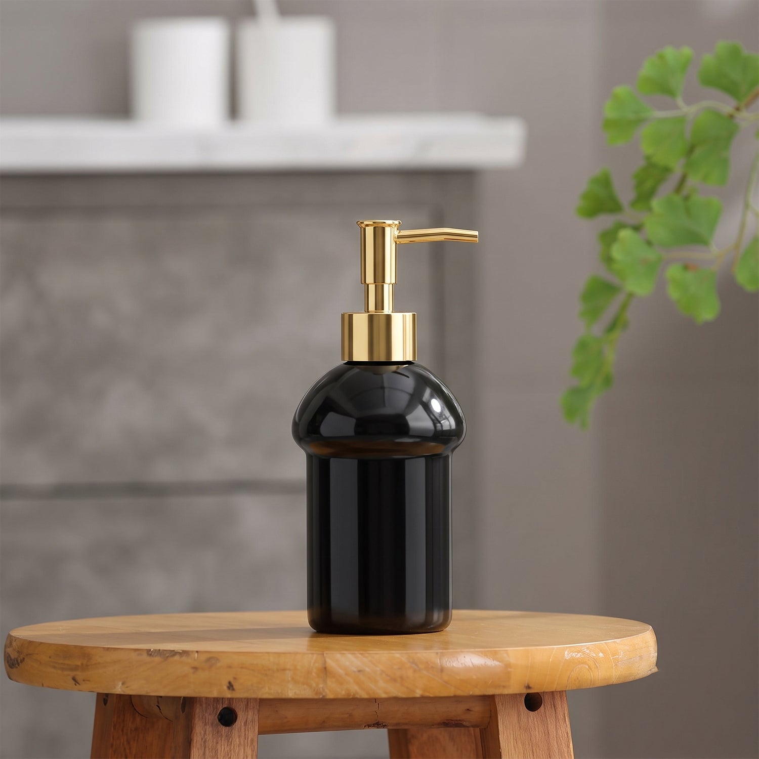 Countertop soap pump bottle in black glass with gold accent