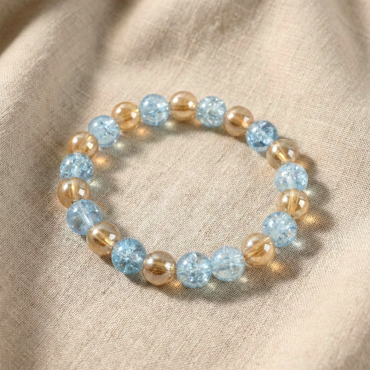 Close-up of glossy dual-tone beads on crystal stretch bracelet