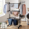 Expandable metal garment rack with three layers for drying clothes.