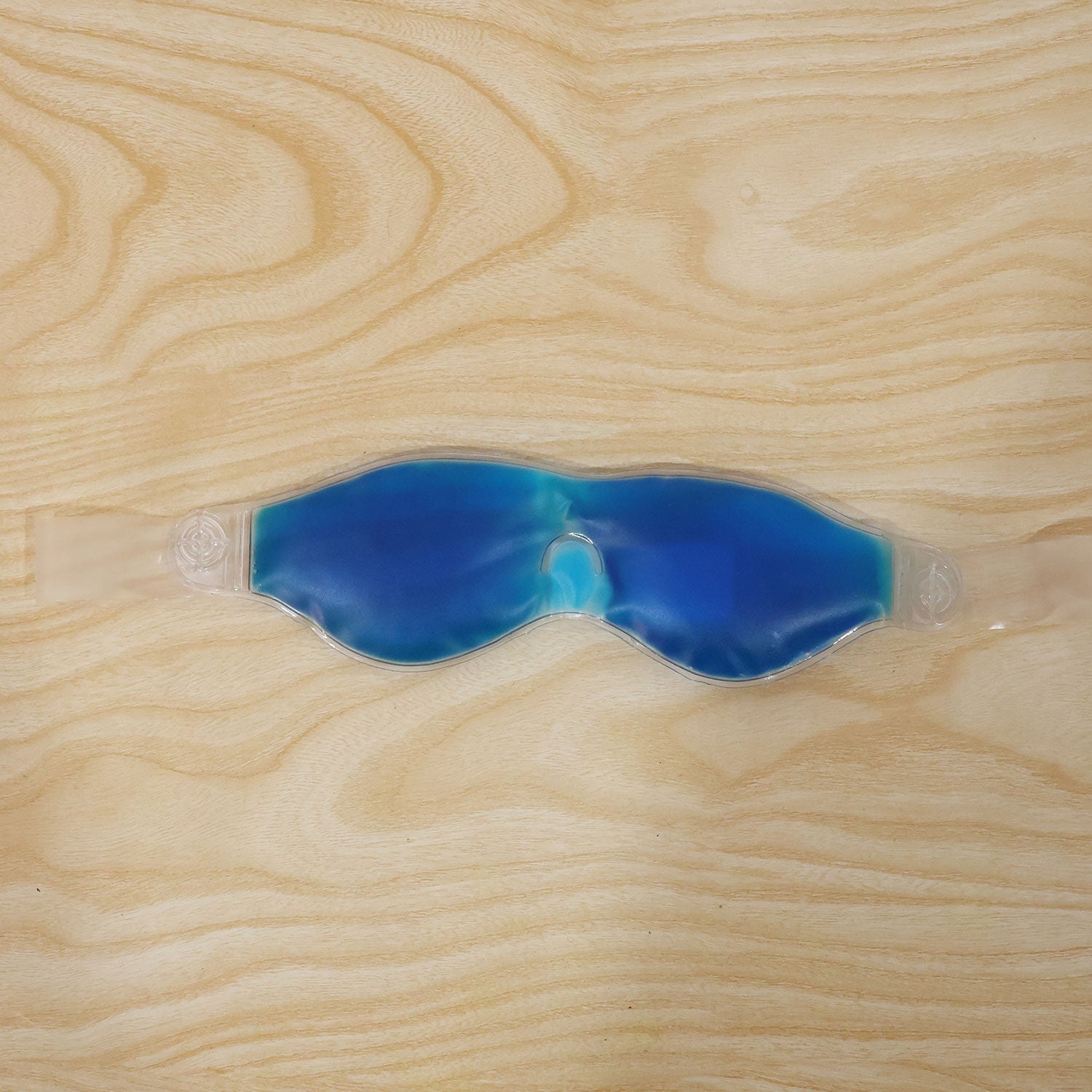 Person wearing a blue cooling gel eye mask for daily use
