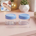 Empty plastic cosmetic cream jar set with spatula and blue lid