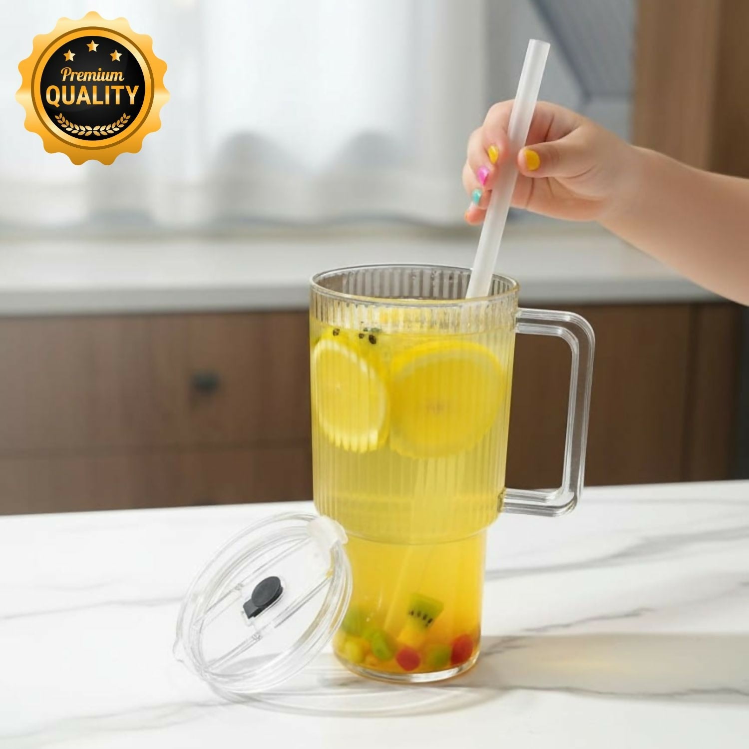Glass tumbler with handle and reusable straw on white background