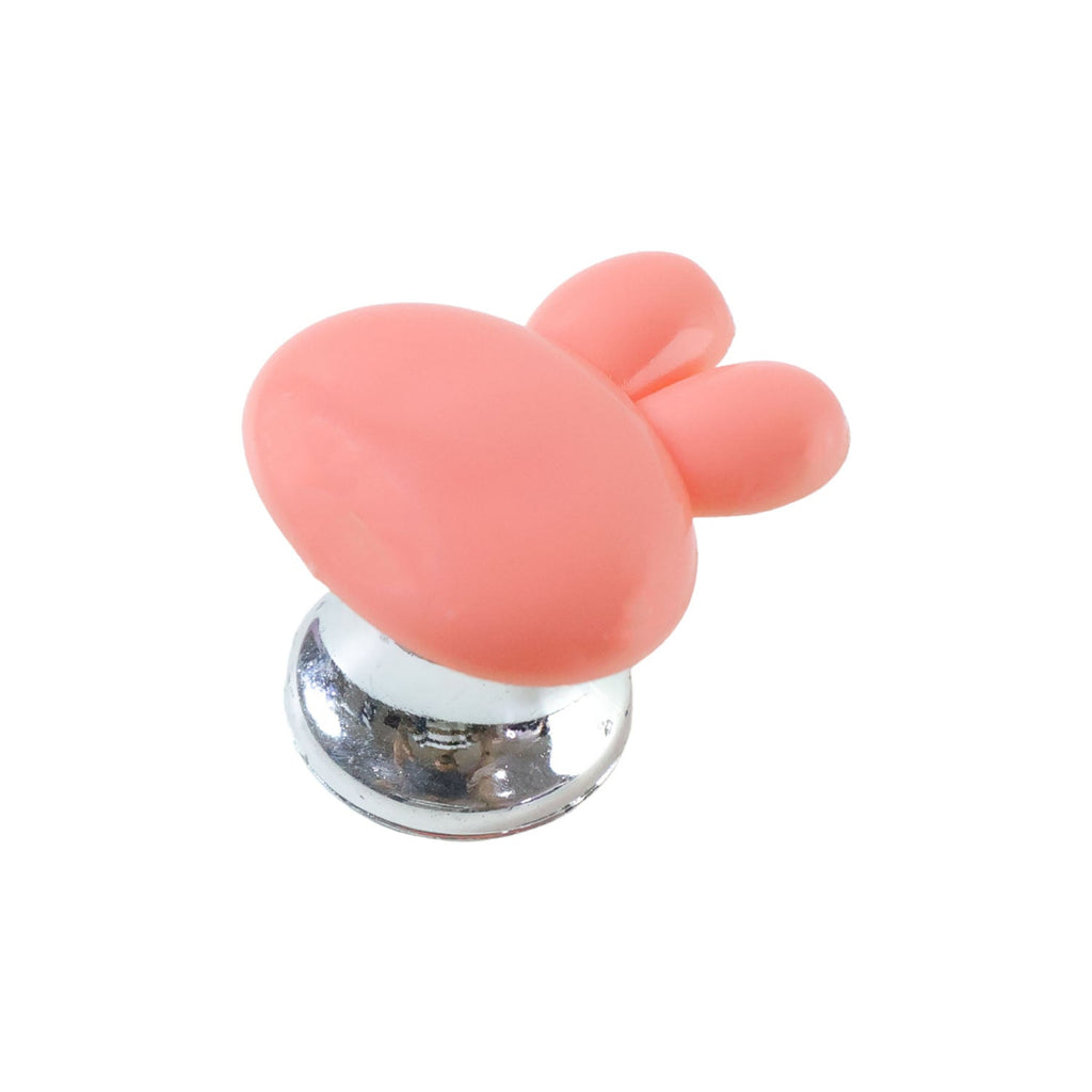 Cabinet pull knob with distinctive bunny ear shape in a colourful kids' room setup.