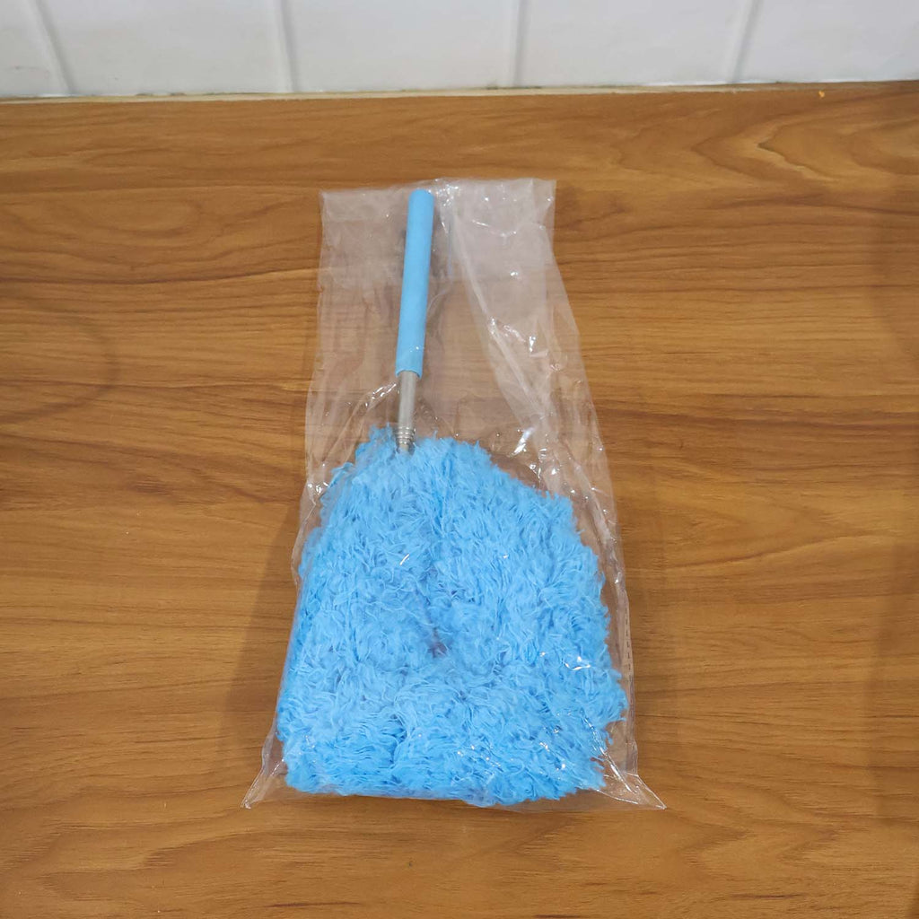 Extendable microfiber cleaning duster in action removing dust from ceiling vents