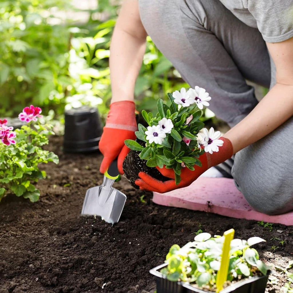 Garden hand trowel with ergonomic soft grip handle for planting