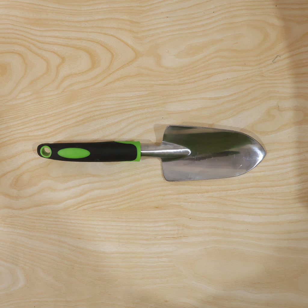 Garden tool in use for planting in flower bed