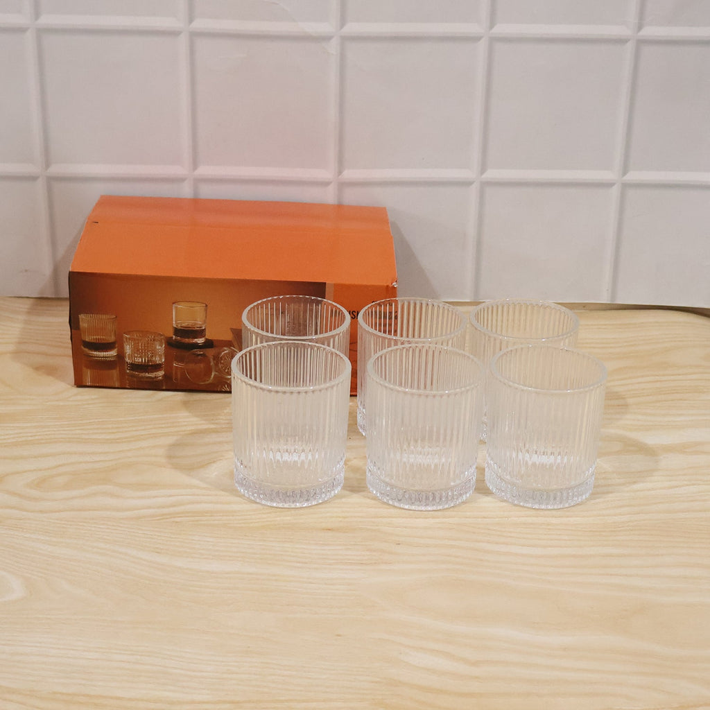Close-up view of a ribbed crystal glass tumbler highlighting its elegant texture