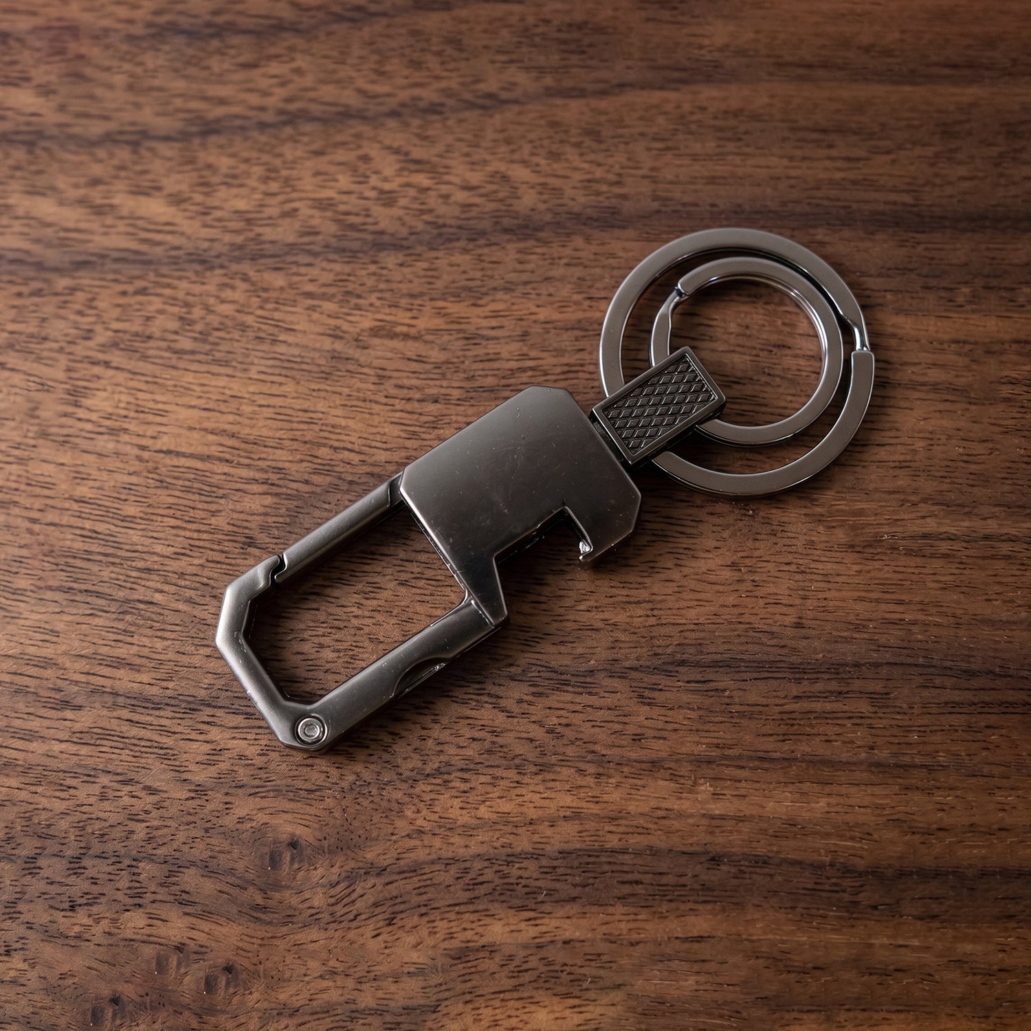 Modern finish metal key holder securely attached to a belt loop, showcasing its utility.