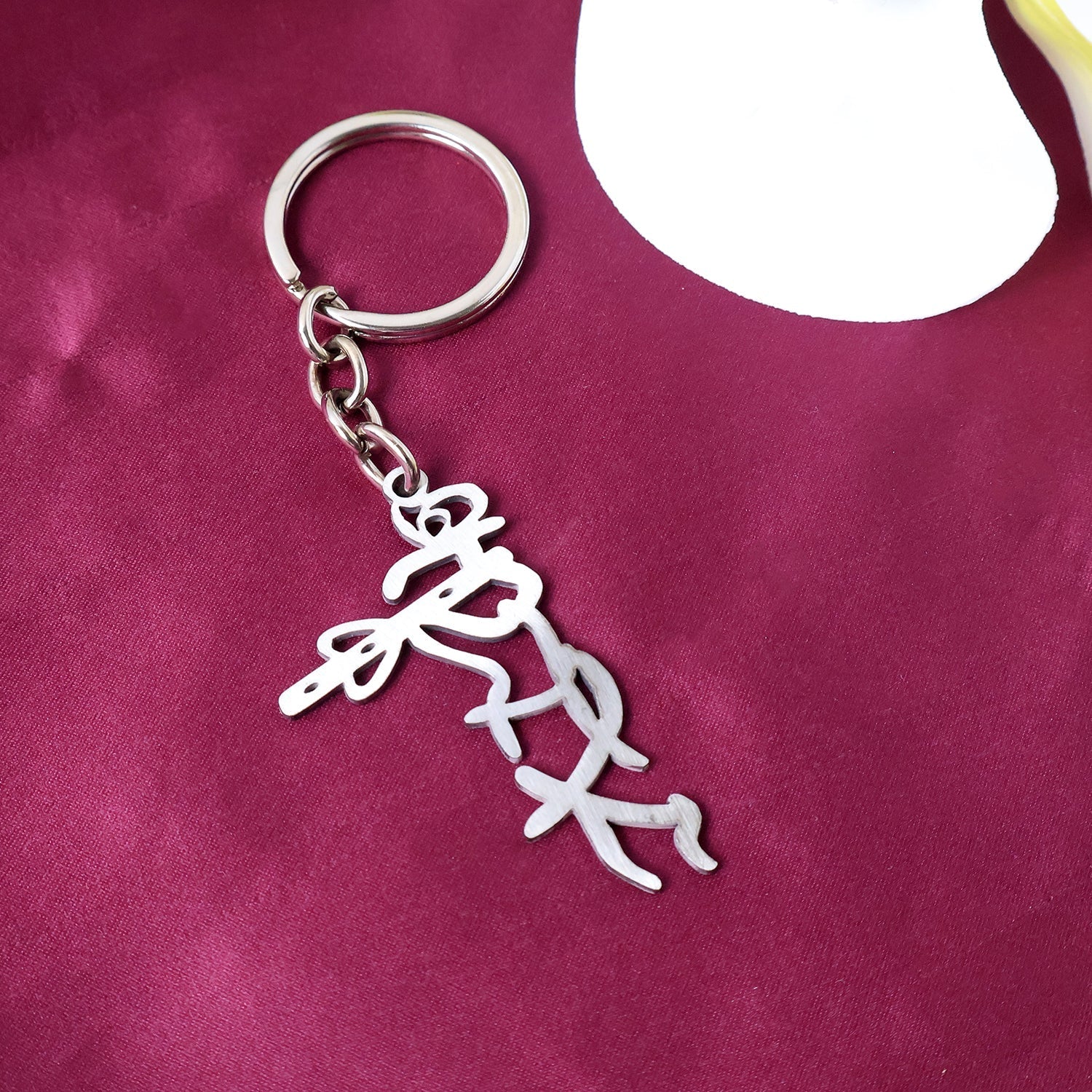 Elegant metal Krishna keychain with polished finish