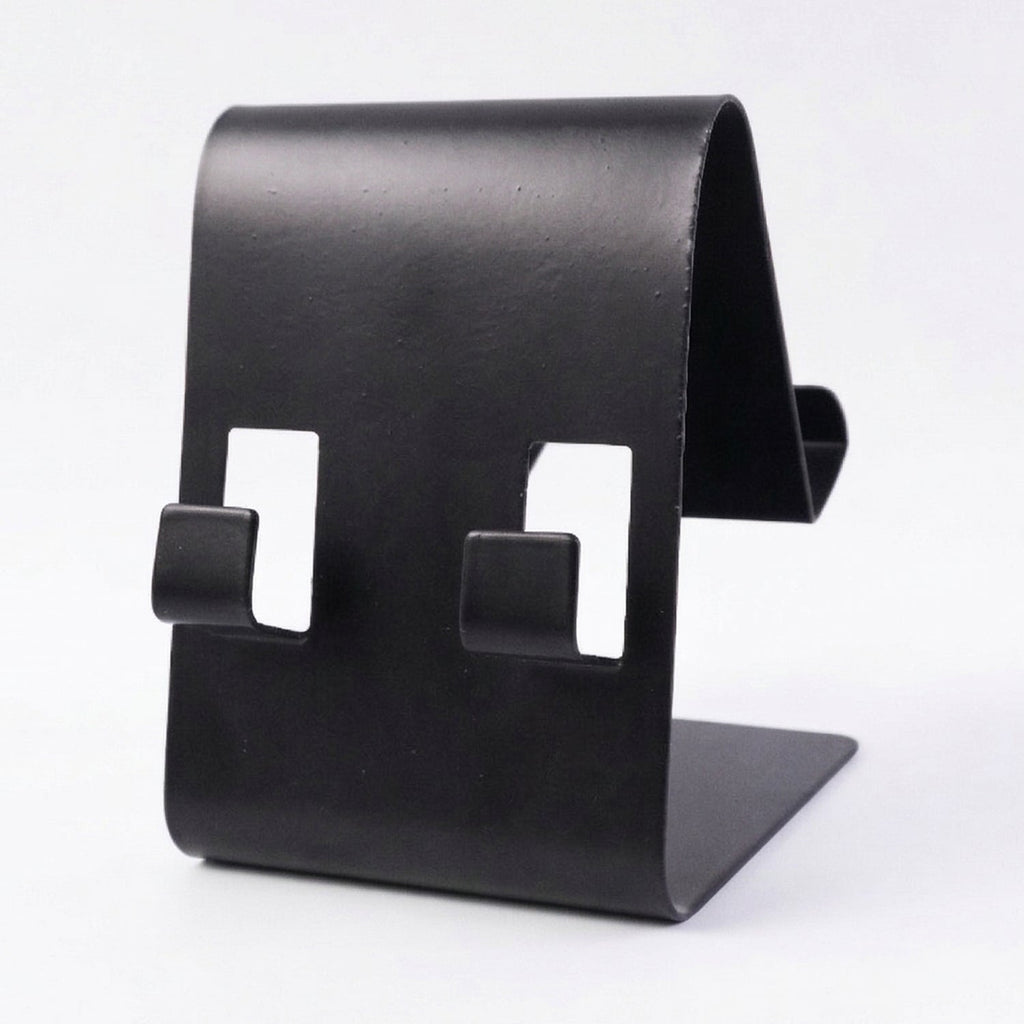 Black metal phone stand holding tablet at side view