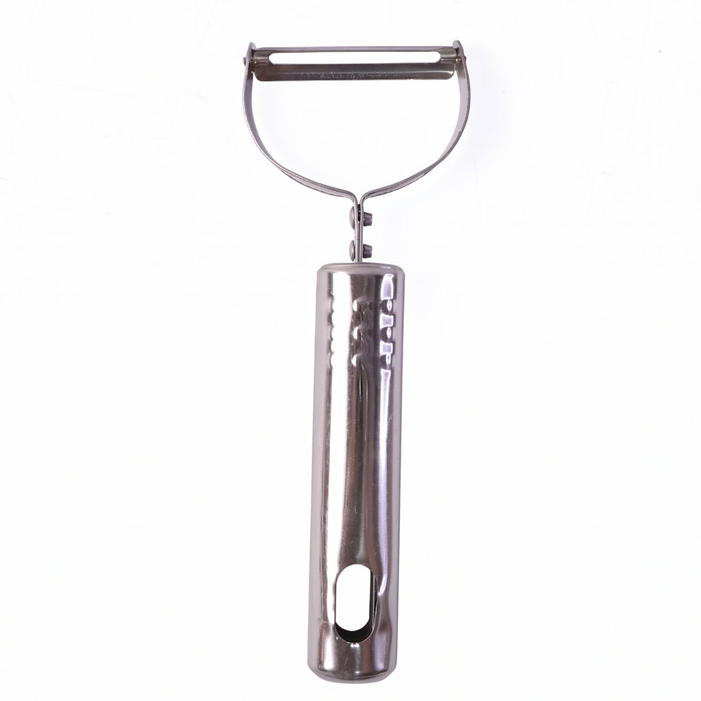 Stainless steel peeler on kitchen counter with peeled vegetables