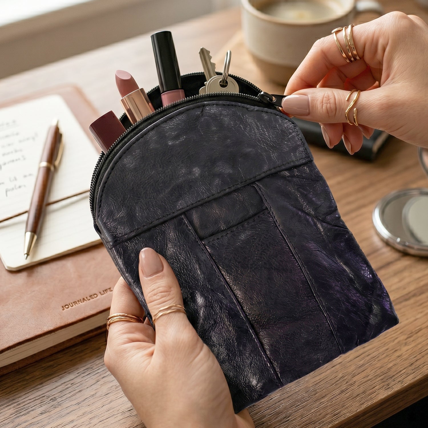 Black leather mini zipper pouch with a sleek design for coins and cards.