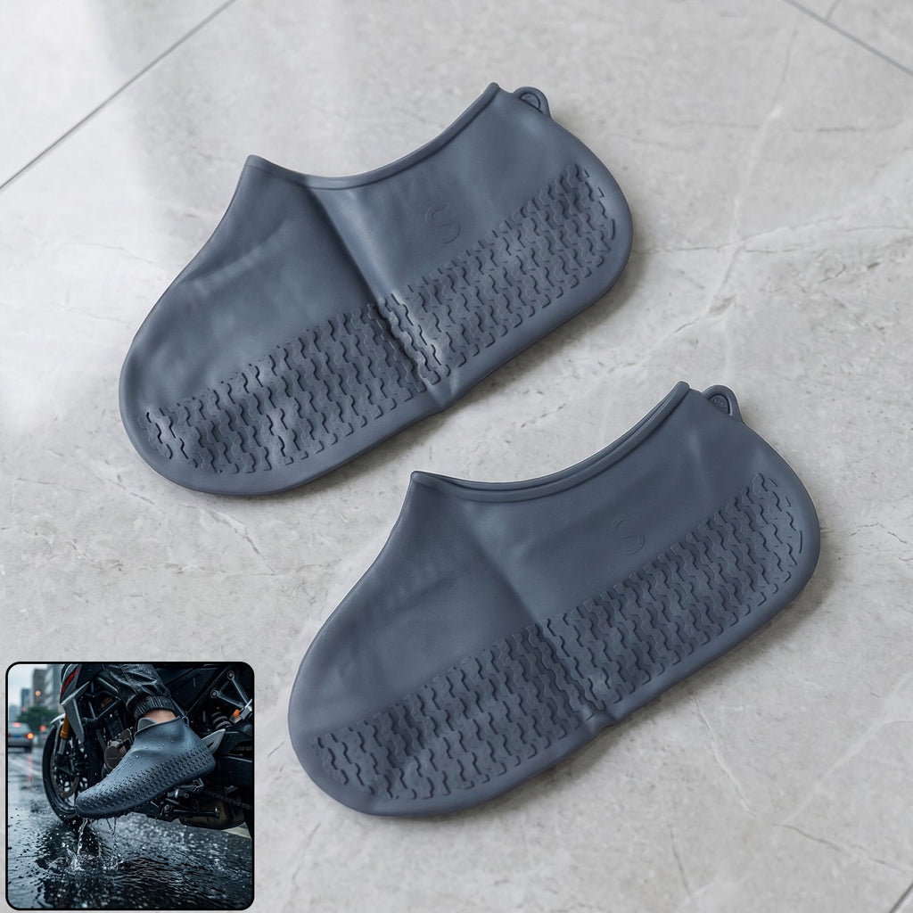 Two dark grey silicone shoe covers are on a light grey tiled floor, with an inset showing a person wearing one on a
