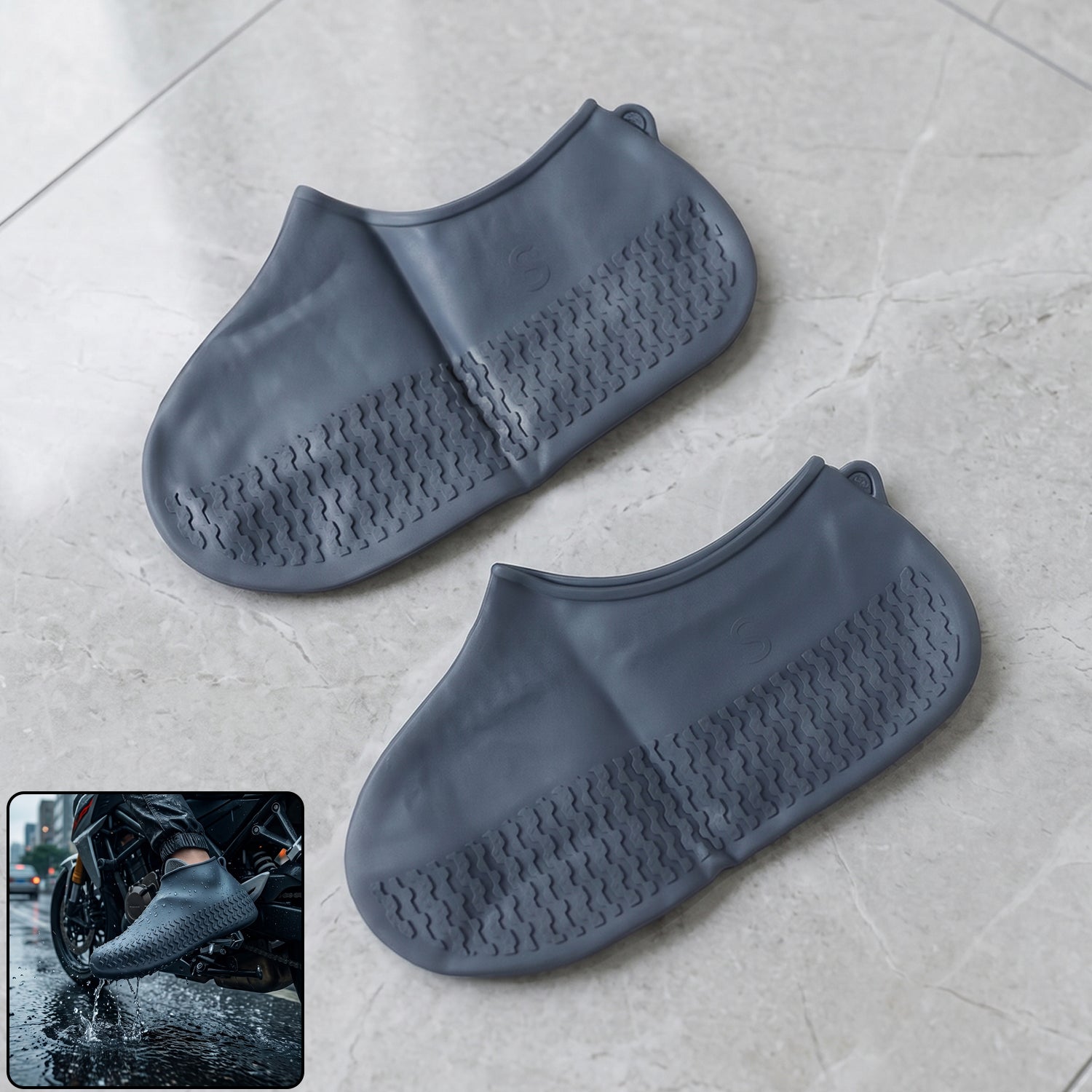 Two dark grey silicone shoe covers are on a light grey tiled floor, with an inset showing a person wearing one on a
