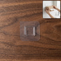 Clear self-adhesive wall hook for easy, tool-free mounting on smooth surfaces.