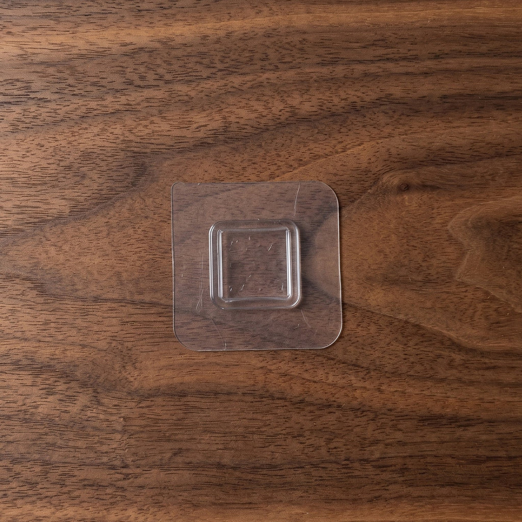 Close-up of a transparent wall sticker hook for discreet storage.