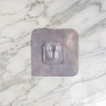 Transparent self adhesive wall hook for kitchen and bathroom organisation.