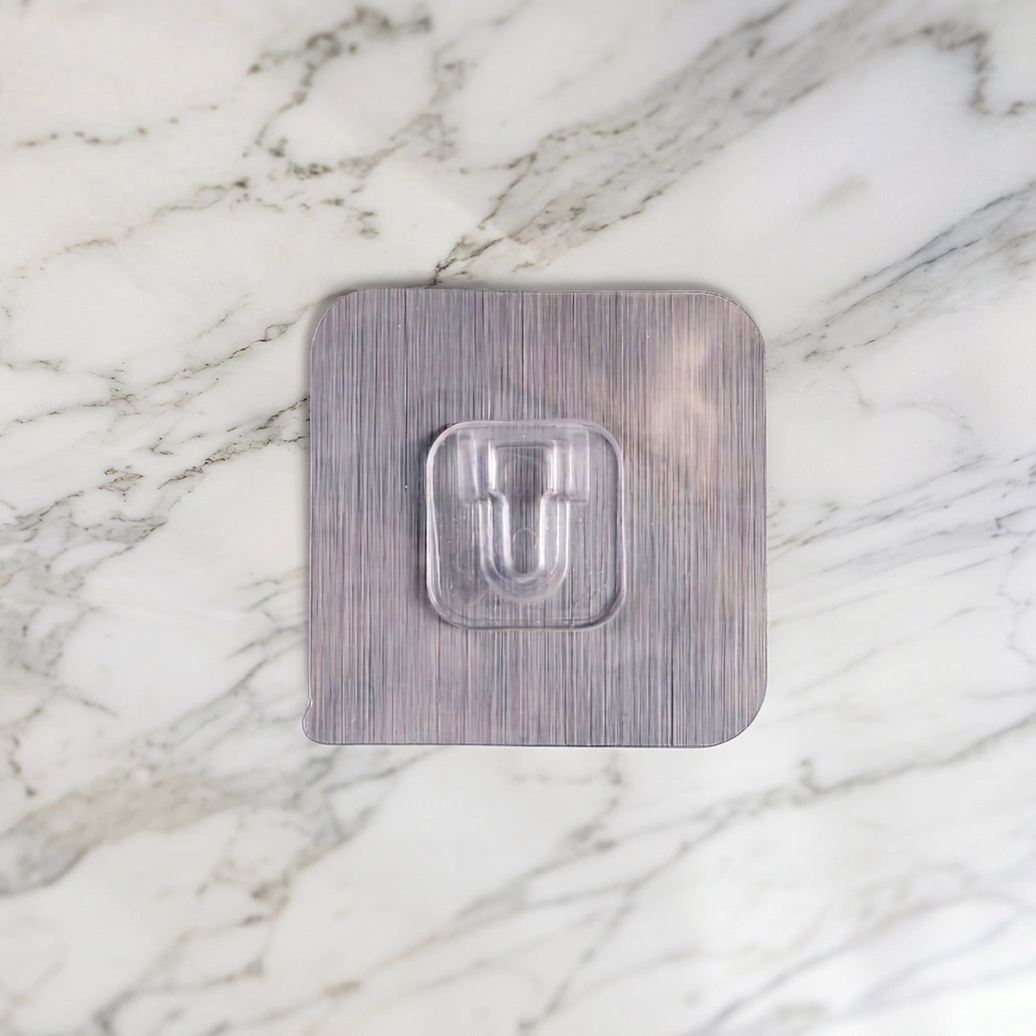 Transparent self adhesive wall hook for kitchen and bathroom organisation.