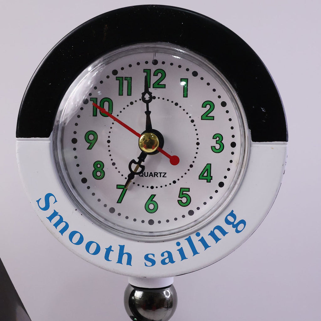 Ship shape clock lamp lit on table showing warm LED ambiance