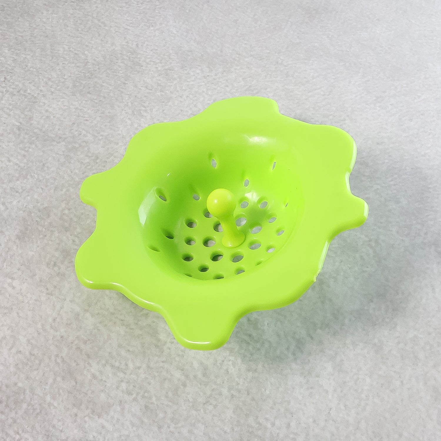 Close-up view of silicone sink strainer showing anti-clog filter holes.