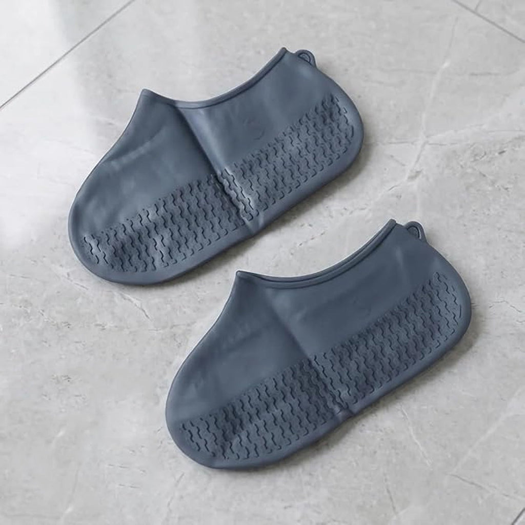 Grey silicone rain shoe cover on white background