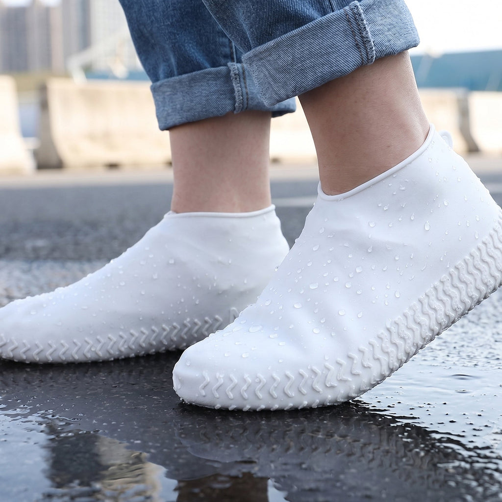 Side view of a small white waterproof silicone rain shoe cover for outdoor activities.
