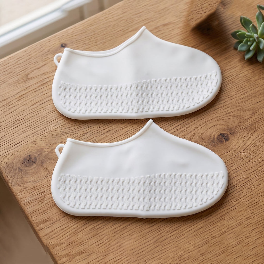 Textured sole detail of the small white waterproof rain shoe cover for grip.