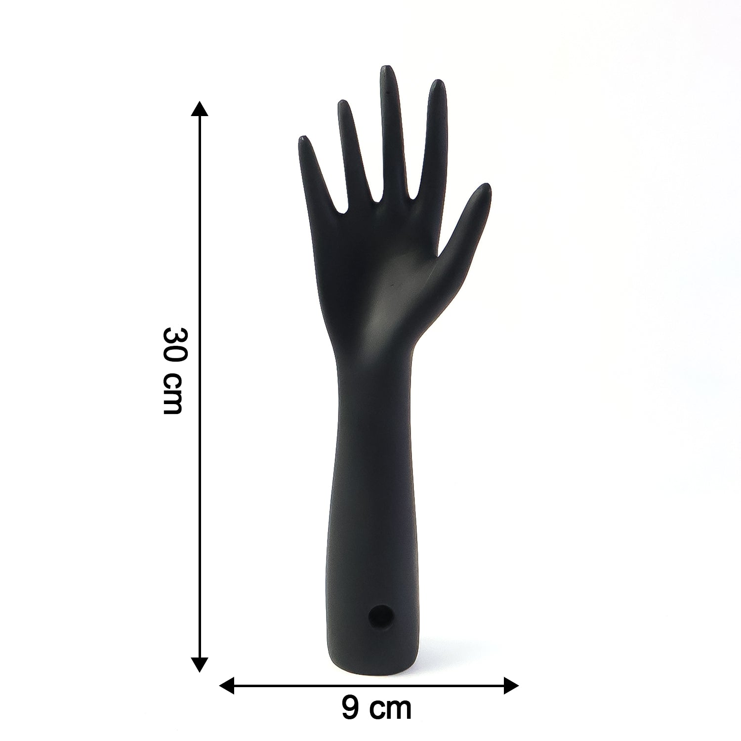 Black hand jewelry display stand placed on shelf for accessories