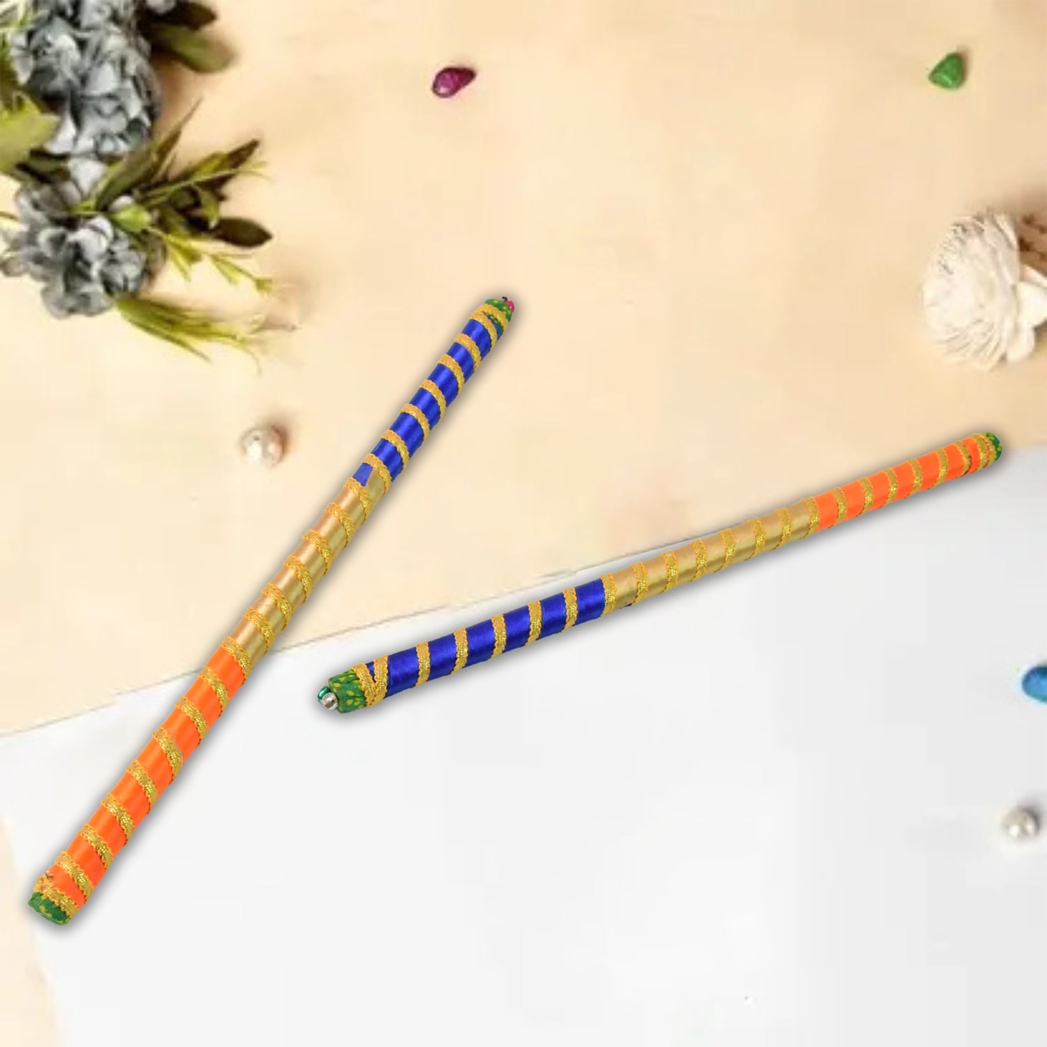 Pair of decorative dandiya sticks featuring vibrant traditional design for festivals