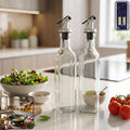 Transparent square glass oil dispenser bottles with stainless steel spouts for kitchen use